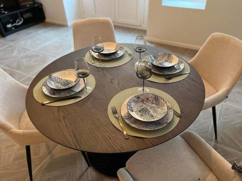 a wooden table with plates and wine glasses on it at Place2be in Ostend