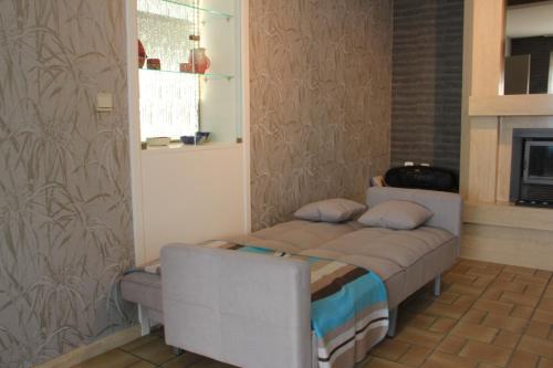 a bedroom with a bed in a room with a fireplace at Maison Spacieuse near Brussels in Meise