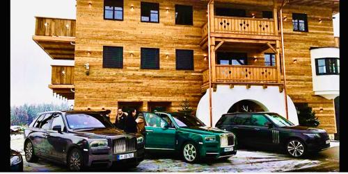 a group of cars parked in front of a building at Das Kitz - Chalet Steuerberg XL Kitzbühel in Kitzbühel