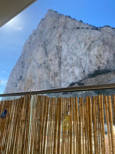 a wooden fence with a mountain in the background at New CP Luxury studio in Gibraltar