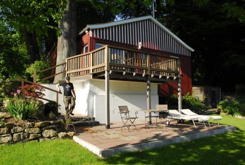 a man standing in front of a house with a balcony at Landhaus Eggert in Münster