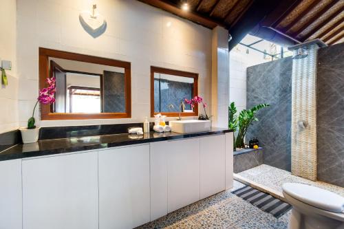 a bathroom with a sink and a shower at Villa Simara in Seminyak