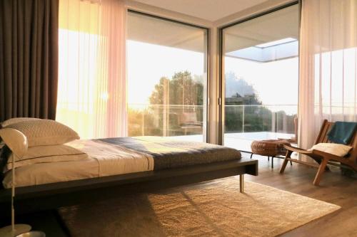 a bedroom with a bed and a large window at Villa Mar & Luz, Porto, Mindelo Beach in Mindelo