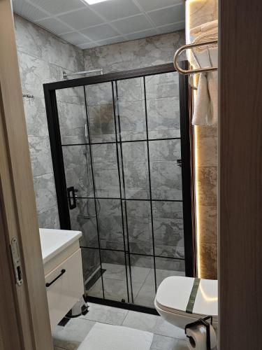 a bathroom with a shower with a glass door at Hotel Devman in Istanbul