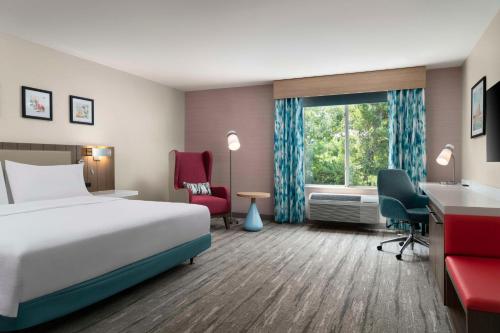 a hotel room with a bed and a window at Hilton Garden Inn Kennett Square in Kennett Square
