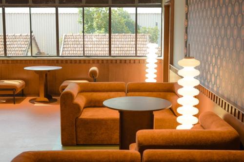 a room with a couch and a table and lights at The Très Hotel in Kuala Lumpur