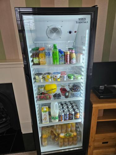 a refrigerator filled with lots of food and drinks at Langhouse Castle Bed and Breakfast in Inverkip