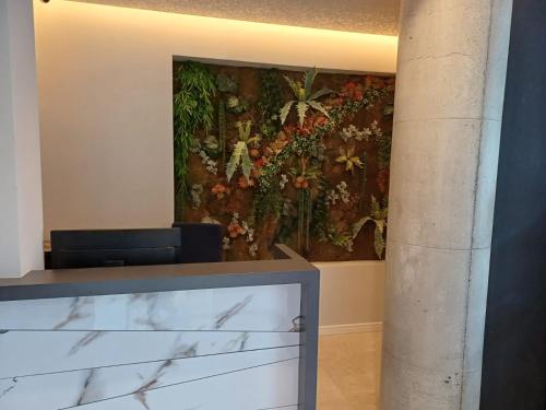 a large painting of flowers on a wall at Oxygen Boutique Hotel in Tirana