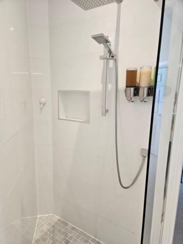 a bathroom with a shower with a glass door at Langhouse Castle Bed and Breakfast in Inverkip