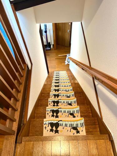 a stairway with a rug with animals on it at Sakura Bloom Separate House in Tokyo