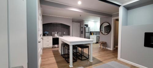 a kitchen with a white counter top in a room at Ski Condo with Garage Parking and Pool in Killington