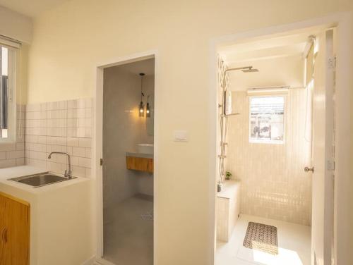 a white bathroom with a sink and a shower at 2-Bedroom apartment for 4 guests, Center-Silom - 3A in Bang Rak