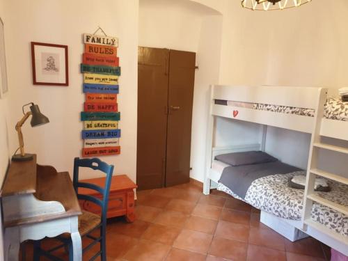 a bedroom with a bunk bed and a desk and a desk at Glimpse of Paradise Beach with Parking in Sori