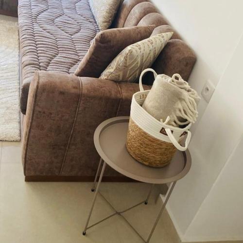 a basket sitting on a table next to a couch at Colina Smir Resort Marina Smir, Tamuda Bay Kabila Beach, M'diq in Sania Torres
