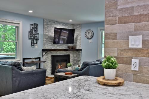 a living room with couches and a fireplace at Fun In Fun Out Ski Home - Upper Unit, Renovated 3BR-2BA, Hot Tub, Close to Resort in Killington