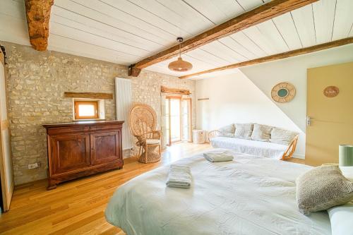 a large bedroom with a bed and a couch at Magnifique maison de campagne aux portes de Sancerre, by Rurals in Gardefort