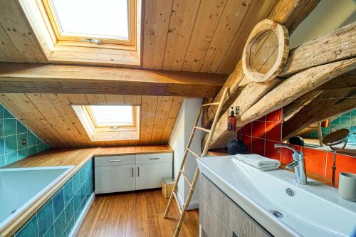 a kitchen with wooden ceilings and a sink at Magnifique maison de campagne aux portes de Sancerre, by Rurals in Gardefort
