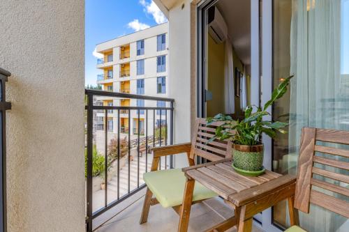 a balcony with a wooden bench and a window at Apart hotel M S KATUNJANIN in Herceg-Novi