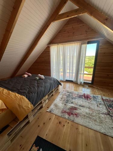 a bedroom with a bed and a large window at Uysal Dağevleri in Bilecik