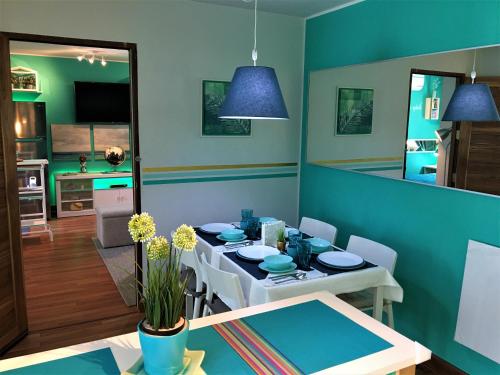 a dining room with a white table and a blue room at White Turquoise -2 Bedrooms Apartment- in Bangkok