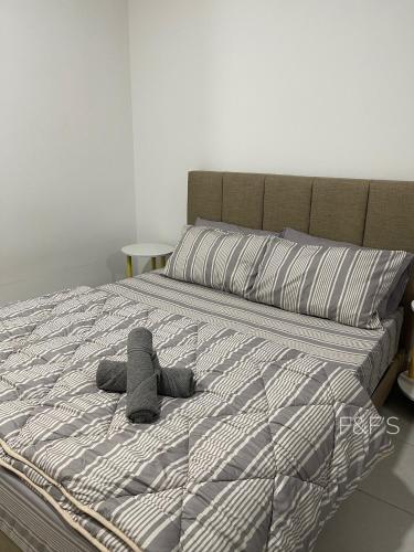 a stuffed animal laying on top of a bed at Netizen Soho #MRT #Wifi #Netflix #Cozy in Kampong Baharu Cheras Batu Sa-Belas
