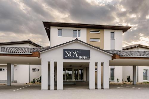 a large white building with a sign on it at Noa Panzio in Vecsés
