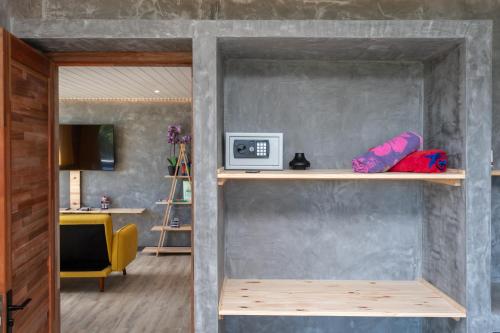 a room with a wall with shelves in it at Twakila Sunset Suites in La Gaulette