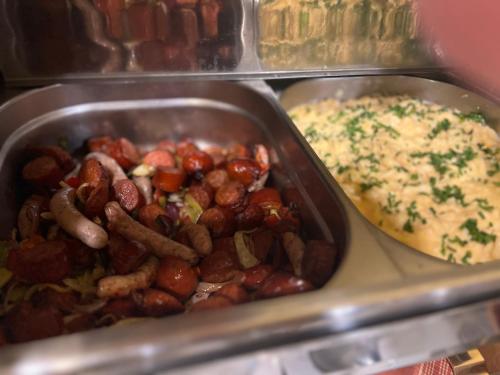 a tray of food with beans and other foods at Alpský Hotel in Špindlerův Mlýn