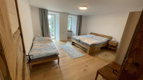 a room with two beds and a couch in it at a knight's splendid apartment in Büren an der Aare