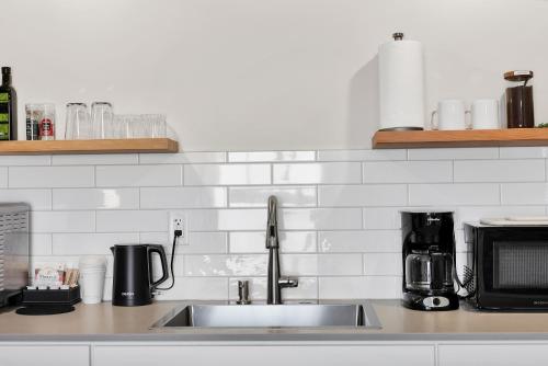 a kitchen counter with a sink and a microwave at Summit Lofts Boutique Hotel in Mount Shasta