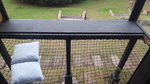 a cage with a white pillow on top of it at Cabanas Villa Helena in Guatavita