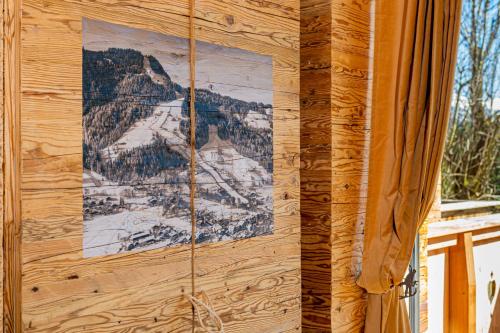 a picture of a mountain on the side of a building at Das Kitz - Chalet Steuerberg XL Kitzbühel in Kitzbühel