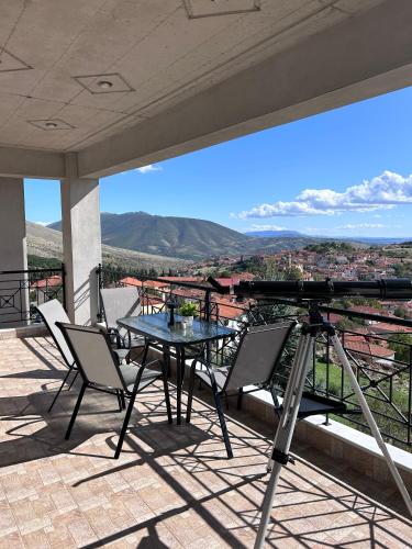 a table and chairs on a balcony with a view at The Watch Tower B in Siátista