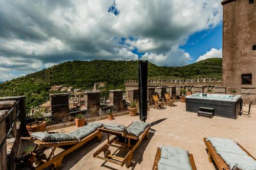 a patio with a hot tub on top of a building at Castello Brancaccio in San Gregorio da Sassola
