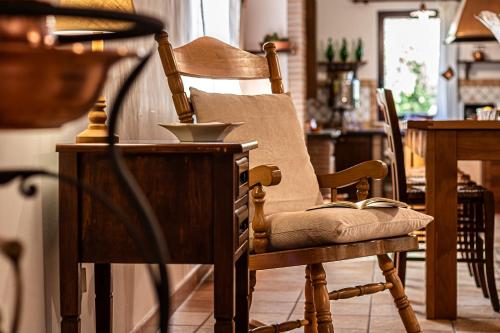 a wooden chair in a kitchen with a table at Copper House in Lanciano