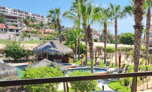 a view of a resort with a swimming pool and palm trees at Beach Eateries Shops 10 min walk Golf view in San José del Cabo