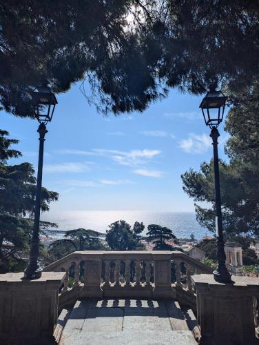 two lights on a bridge with a view of the ocean at Casa Moret in Sanremo