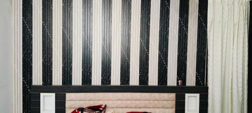 a black and white striped wall in a room at Sindu Villa in Lucknow