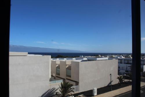a view of a building with the ocean in the background at Casa Gara in Costa Teguise
