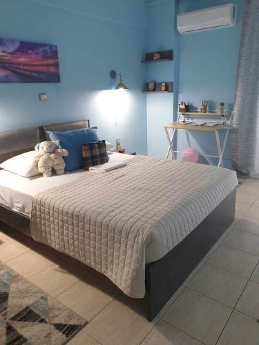 a bedroom with a bed with a teddy bear on it at Piraeus Seaside Apartment Escape in Piraeus
