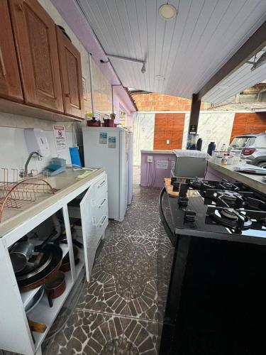 a kitchen with a sink and a stove in it at Residencial Napolitan in Manaus