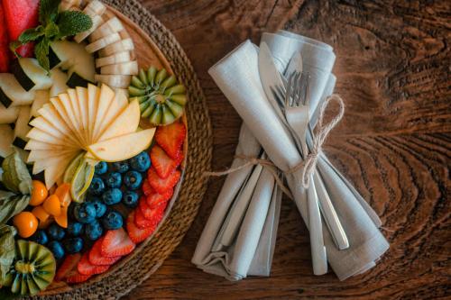 two baskets filled with fruits and vegetables on a wooden table at SWISS MORAIRA HOTEL & SPA - Adults only in Moraira