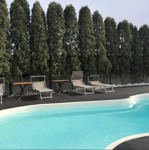 a group of chairs and a table next to a pool at Sport Hotel 2 in Cherkasy