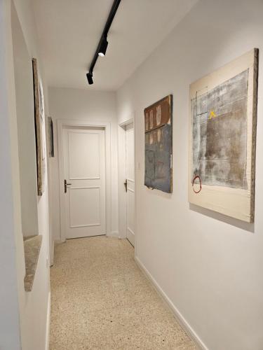 a hallway with paintings on the walls of a room at 3 bedroom apt in prime location 5m away from beach in Is-Swieqi