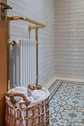 a bathroom with a radiator and a basket on the floor at 1 bed house in Hampshire in Chandlers Ford