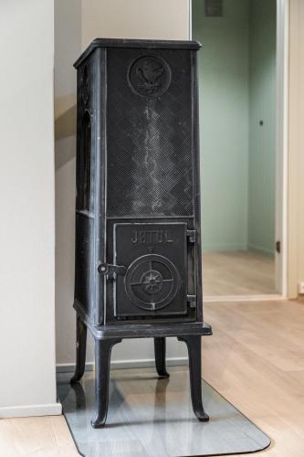 a black stove sitting on a table in a room at Skrenten Apartment in Horten