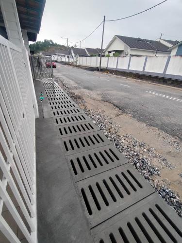 a storm drain on the side of a street at Angah Homestay in Kampong Chabang