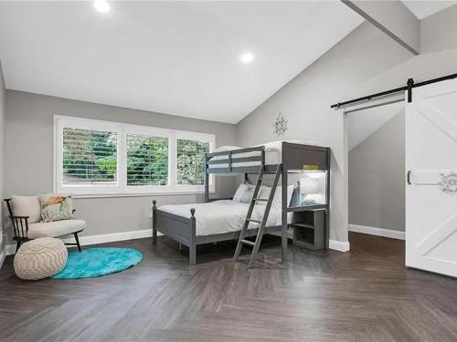 a bedroom with a bunk bed and a chair at Georgia Lakeside Getaway with Private Pool in Flowery Branch
