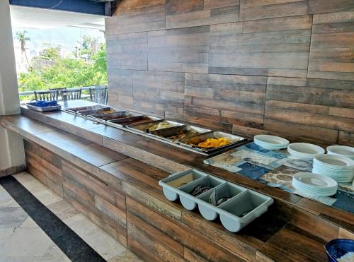 a kitchen with a buffet of food on a counter at Hotel Aristos Acapulco in Acapulco