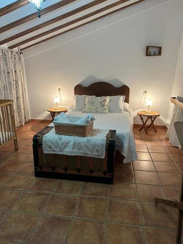 a bedroom with a large bed with two tables at La Cueva in Vélez Blanco